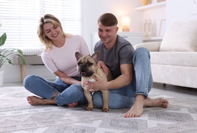 Photo of Happy couple with cute dog at home