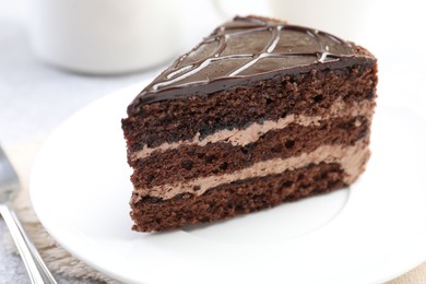 Photo of Piece of delicious chocolate cake on table, closeup