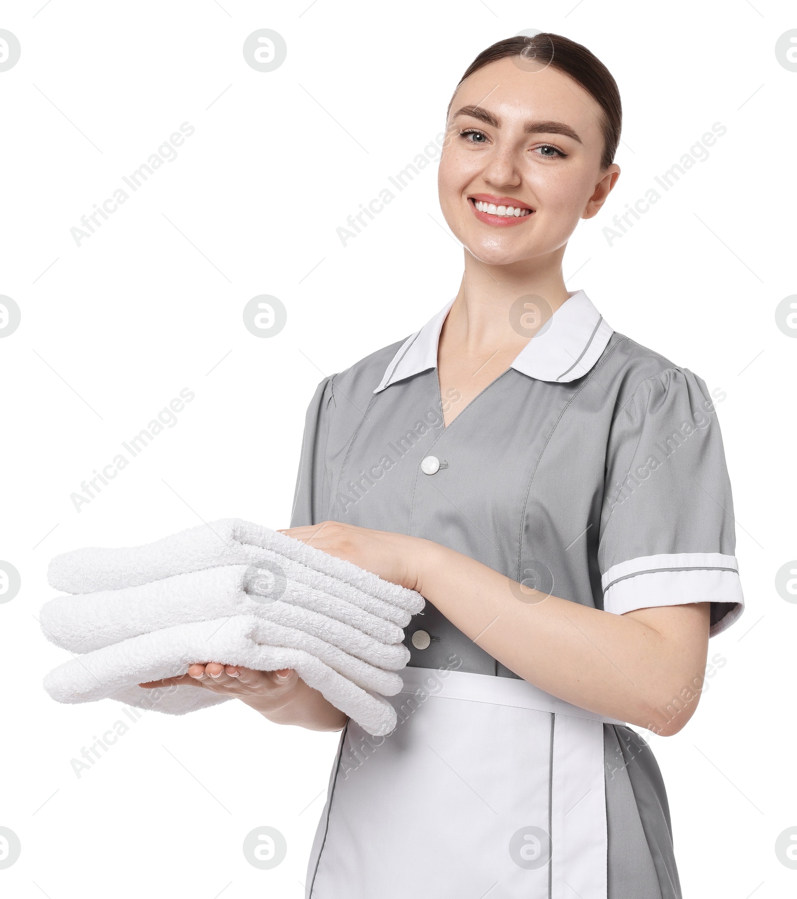 Chambermaid with stack of clean towels on white background Photo of Chambermaid with stack of clean towels on white background