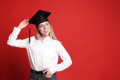 Photo of Happy student after graduation on red background. Space for text