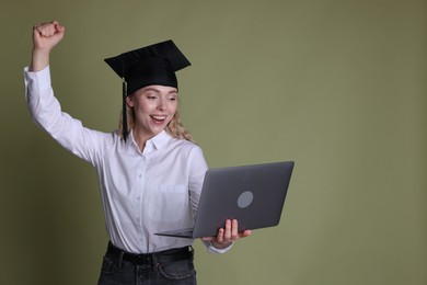Photo of Happy student with laptop after graduation on green background. Space for text