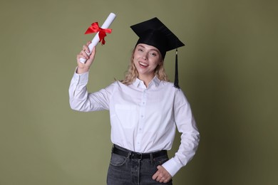 Photo of Happy student with diploma after graduation on green background