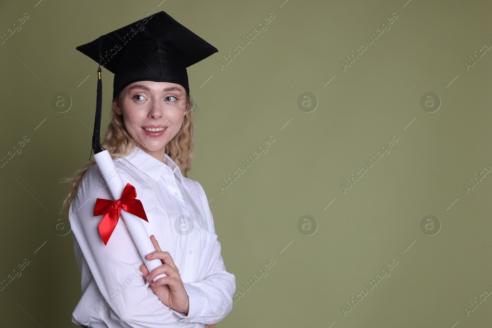 Happy student with diploma after graduation on green background. Space for text Photo of Happy student with diploma after graduation on green background. Space for text