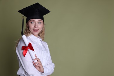Photo of Happy student with diploma after graduation on green background. Space for text
