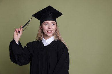 Photo of Happy student after graduation on green background. Space for text