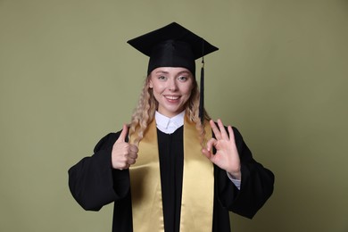 Photo of Happy student gesturing after graduation on green background