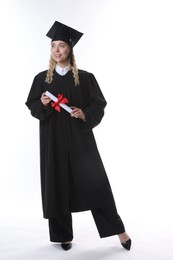 Photo of Happy student with diploma after graduation on white background