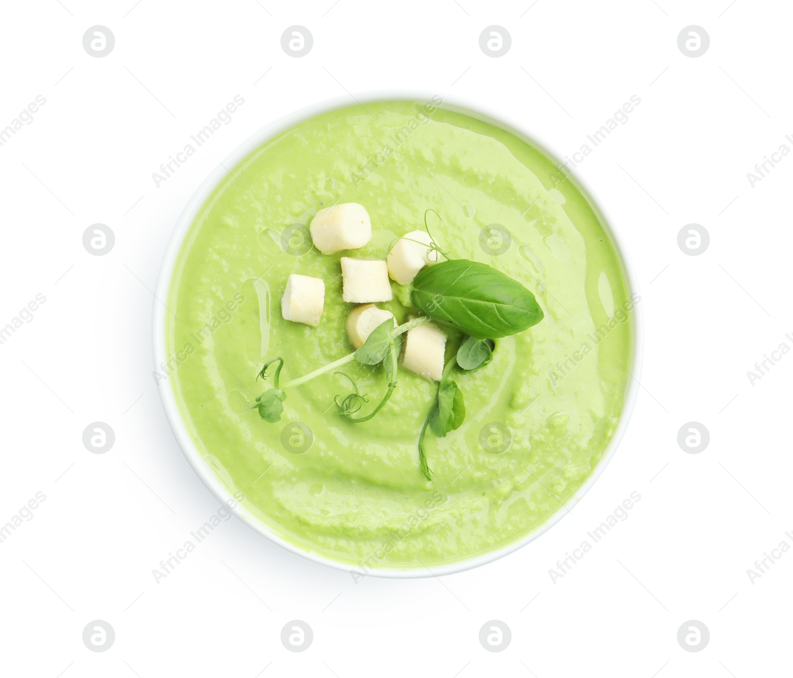 Photo of Tasty pea cream soup with croutons, basil and microgreens isolated on white, top view