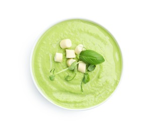 Photo of Tasty pea cream soup with croutons, basil and microgreens isolated on white, top view