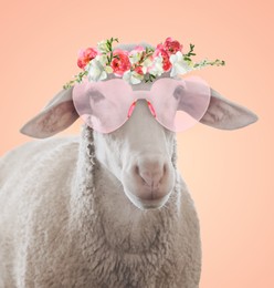 Image of Adorable sheep with pink heart-shaped sunglasses and flower wreath against pink beige background