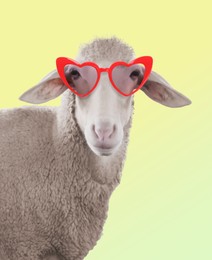 Image of Adorable sheep with heart-shaped sunglasses against yellow gradient background