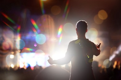 Image of Man performing on stage of open air festival