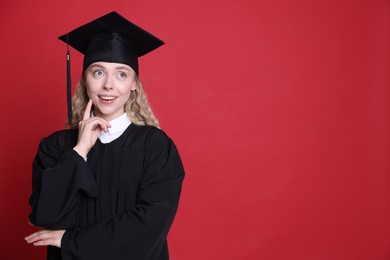 Photo of Happy student after graduation on red background. Space for text