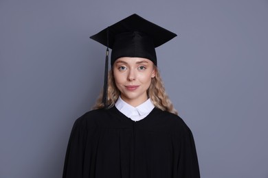 Photo of Student in mortarboard after graduation on grey background
