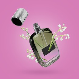 Image of Lilies of the valley and bottle of perfume in air on violet background