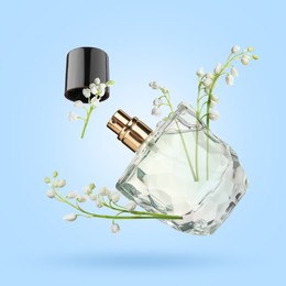 Image of Lilies of the valley and bottle of perfume in air on light blue background