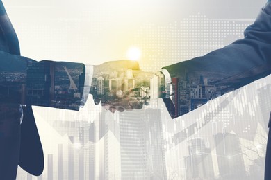 Image of Businessmen shaking hands, double exposure with cityscape. Successful partnership and startup