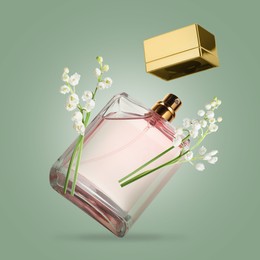 Image of Lilies of the valley and bottle of perfume in air on greyish green background
