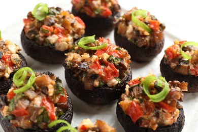Photo of Many delicious stuffed mushrooms on table, closeup