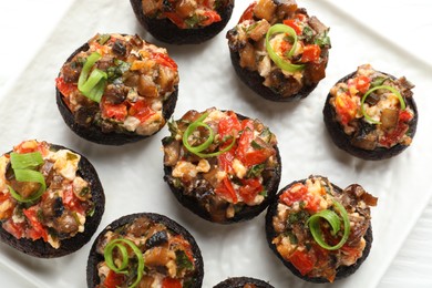 Photo of Delicious stuffed mushrooms on table, top view