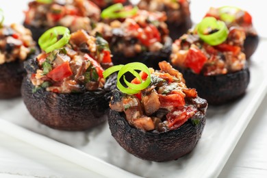 Photo of Many delicious stuffed mushrooms on table, closeup