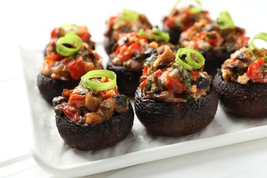 Photo of Delicious stuffed mushrooms on white table, closeup