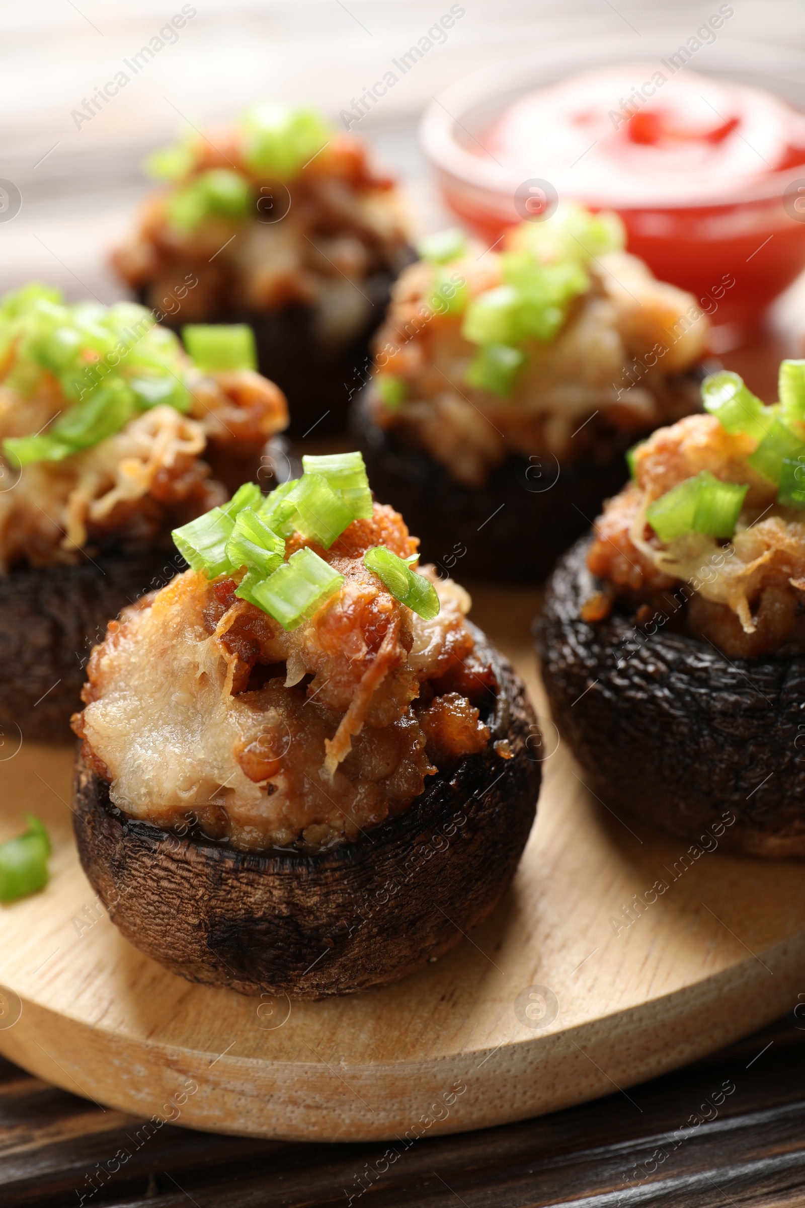 Delicious stuffed mushrooms and sauce on table, closeup Photo of Delicious stuffed mushrooms and sauce on table, closeup