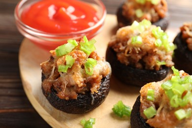 Photo of Delicious stuffed mushrooms and sauce on table, closeup