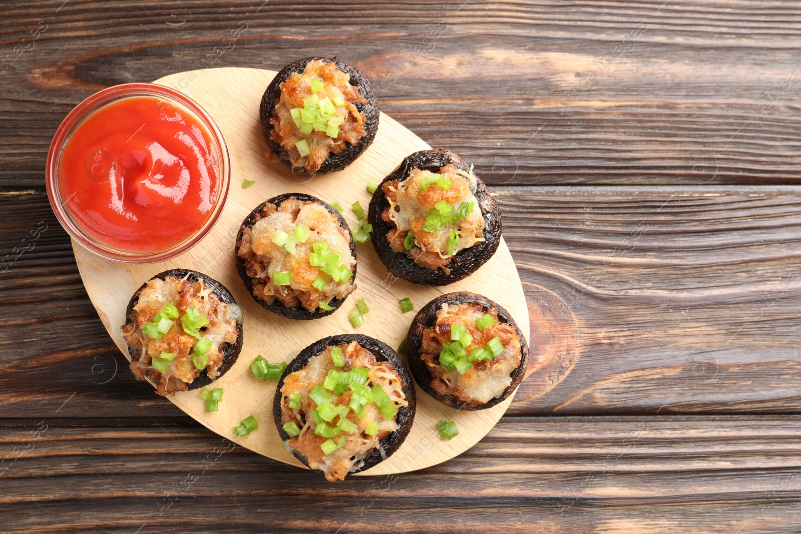 Delicious stuffed mushrooms and sauce on wooden table, top view. Space for text Photo of Delicious stuffed mushrooms and sauce on wooden table, top view. Space for text