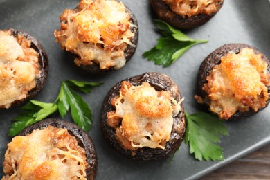 Photo of Delicious stuffed mushrooms with parsley on table, top view