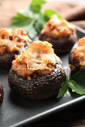 Photo of Delicious stuffed mushrooms with parsley on table, closeup