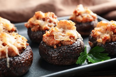 Photo of Delicious stuffed mushrooms with parsley on table, closeup