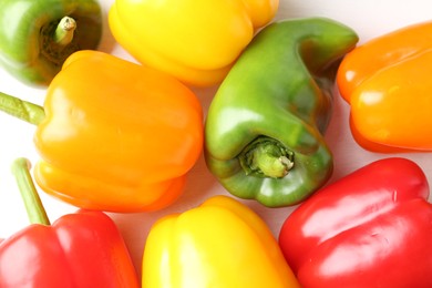 Photo of Ripe colorful bell peppers on white table, flat lay