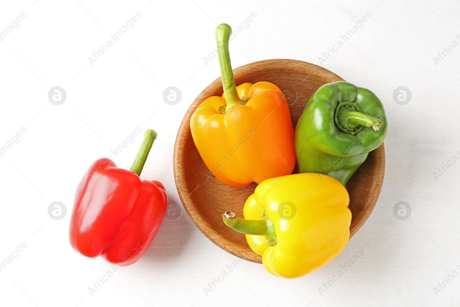 Ripe colorful bell peppers on white table, flat lay Photo of Ripe colorful bell peppers on white table, flat lay