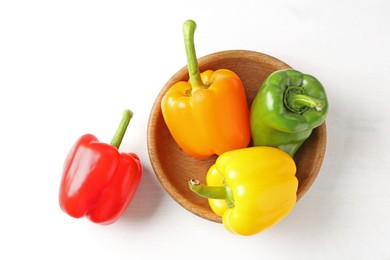 Photo of Ripe colorful bell peppers on white table, flat lay