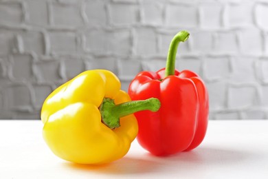 Photo of Ripe colorful bell peppers on white table