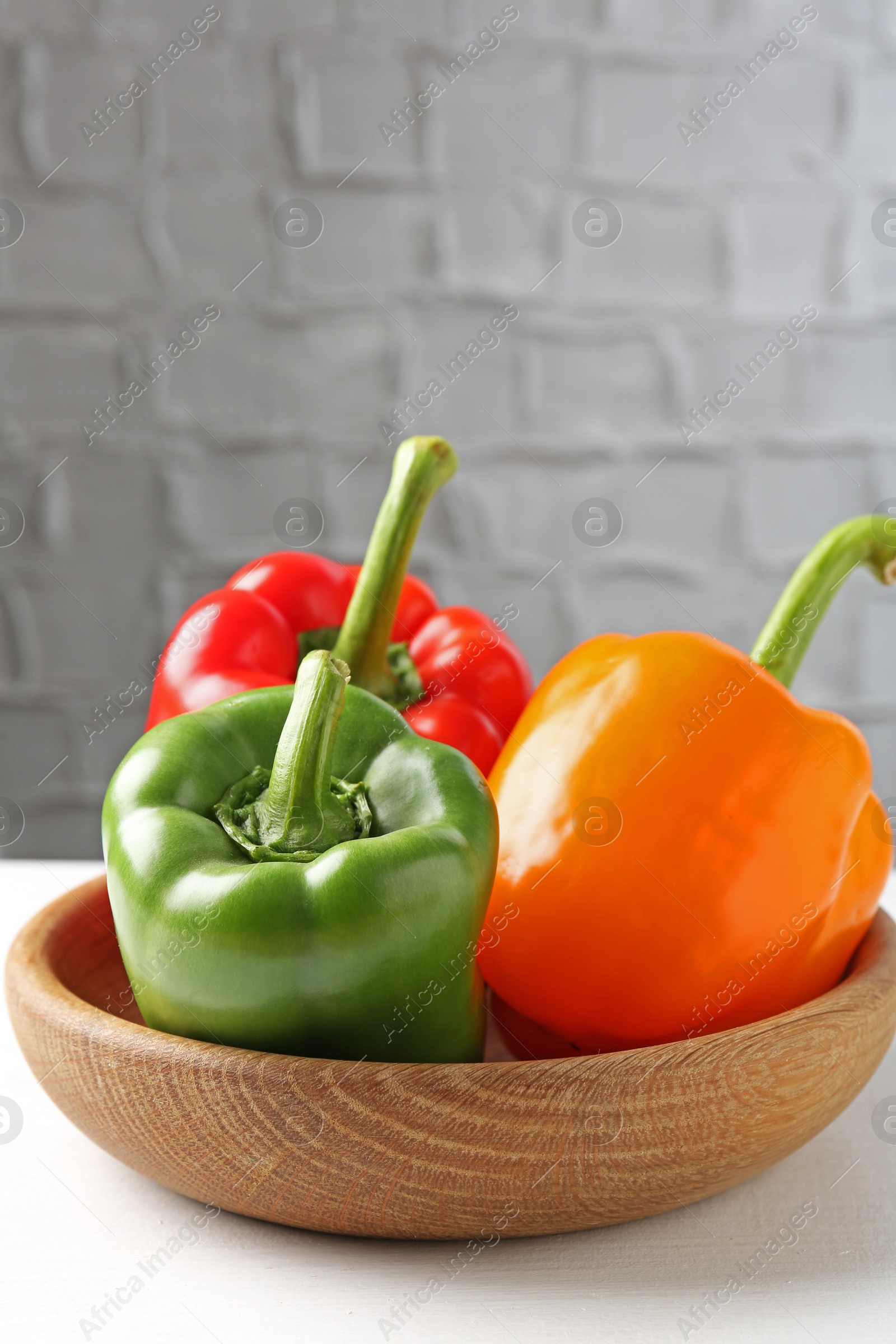 Ripe colorful bell peppers on white table. Space for text Photo of Ripe colorful bell peppers on white table. Space for text