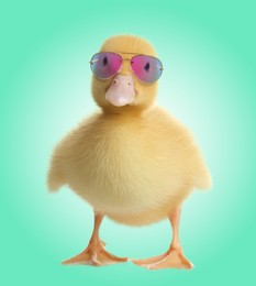 Image of Cute duckling with sunglasses against turquoise gradient background