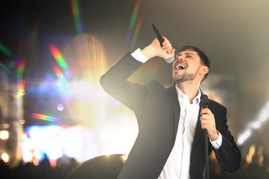 Image of Handsome man singing at open air festival