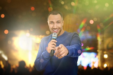 Image of Young handsome man singing at open air festival