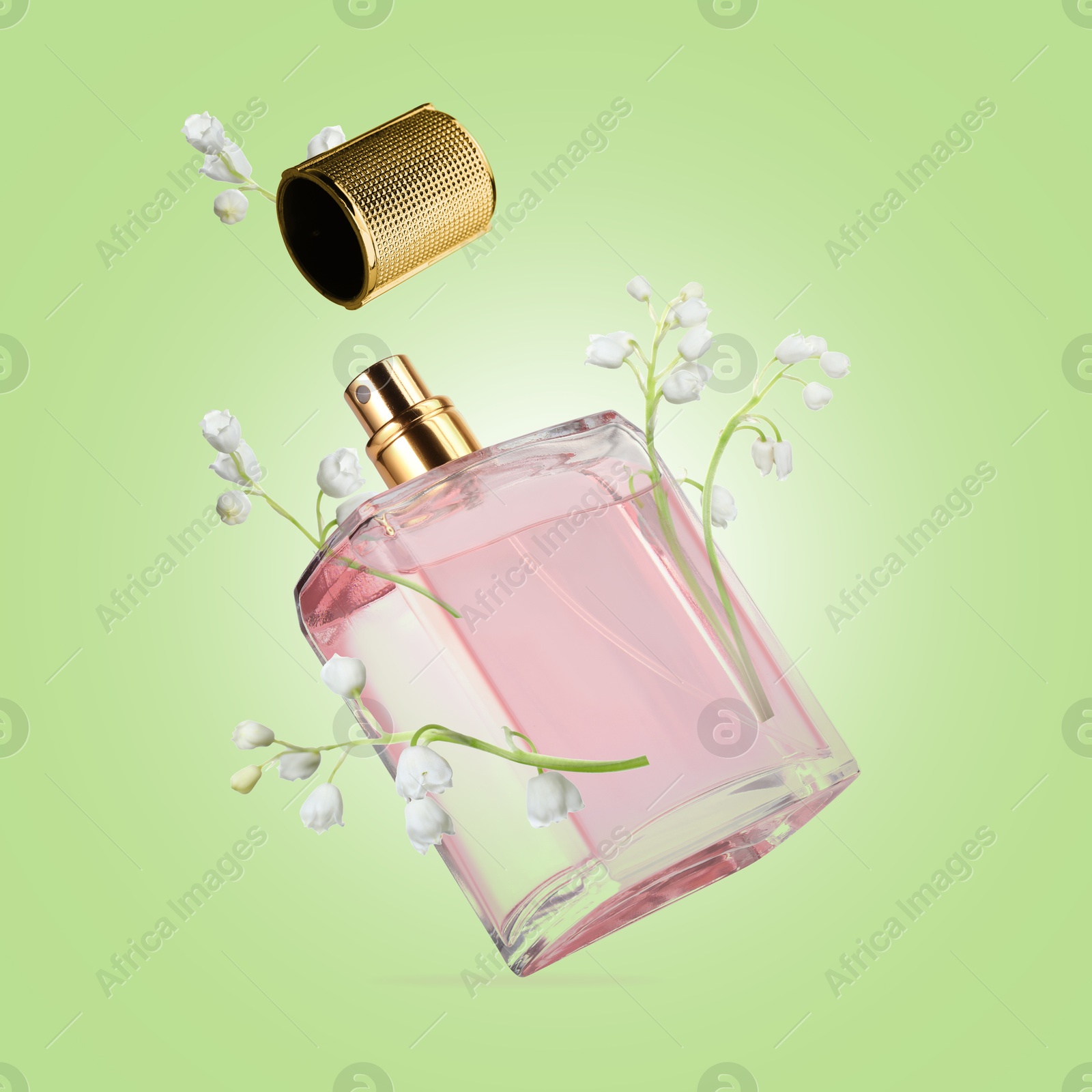 Lilies of the valley and bottle of perfume in air on light green background Image of Lilies of the valley and bottle of perfume in air on light green background