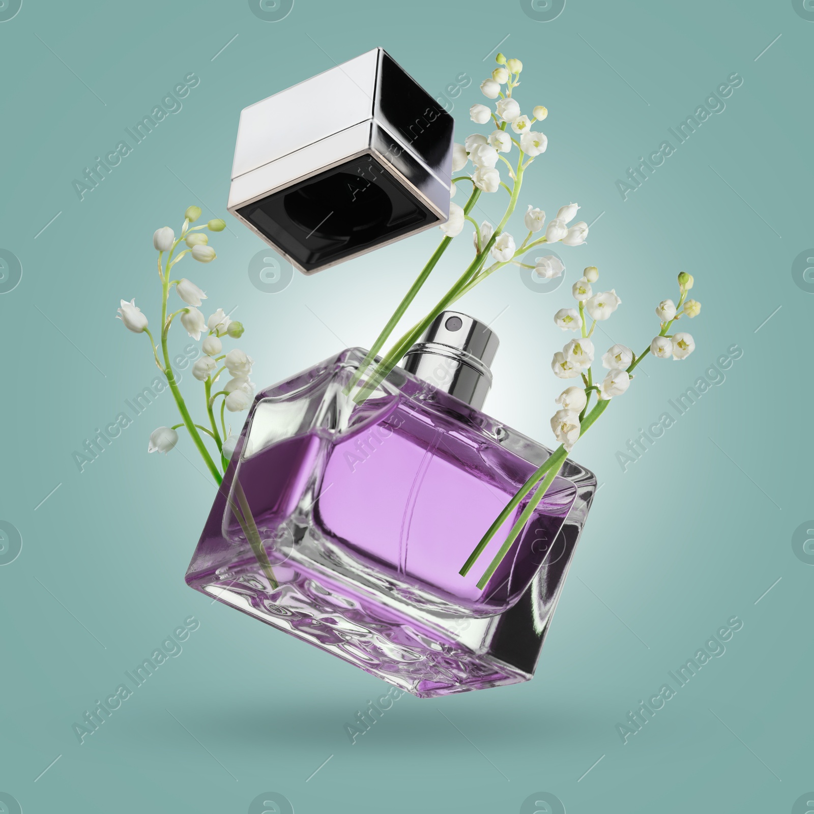 Image of Lilies of the valley and bottle of perfume in air on pale turquoise background