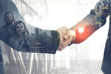 Image of Businessmen shaking hands, double exposure with cityscape and workers. Successful partnership and startup