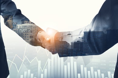 Image of Businessmen shaking hands, double exposure with cityscape. Successful partnership and startup