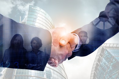 Image of Businessmen shaking hands, double exposure with cityscape and workers. Successful partnership and startup