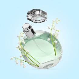 Image of Lilies of the valley and bottle of perfume in air on light blue background