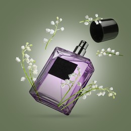 Image of Lilies of the valley and bottle of perfume in air on olive color background