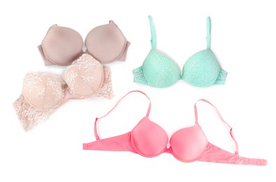 Image of Bras of different colors isolated on white, collage. Top view