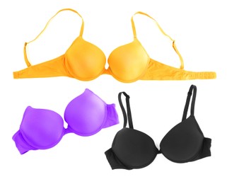 Image of Bras of different colors isolated on white, collage. Top view
