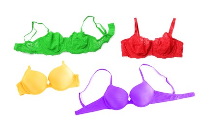 Image of Bras of different colors isolated on white, collage. Top view